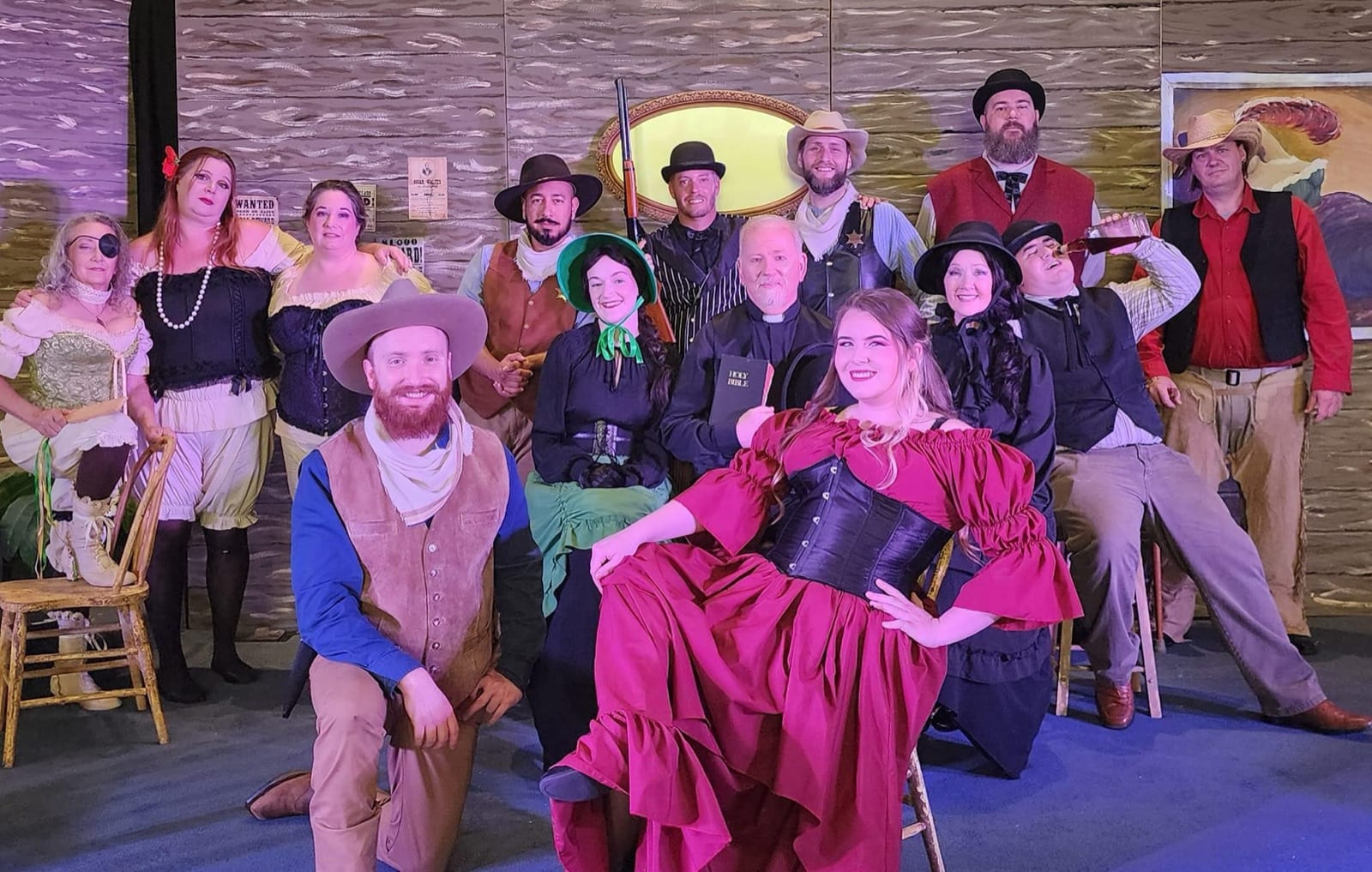 The cast of a Diversity Theater Company western production posing together on stage