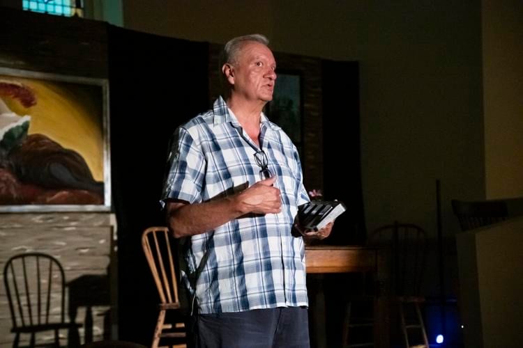 Maury Evans speaking on the Diversity Theater stage while holding a script
