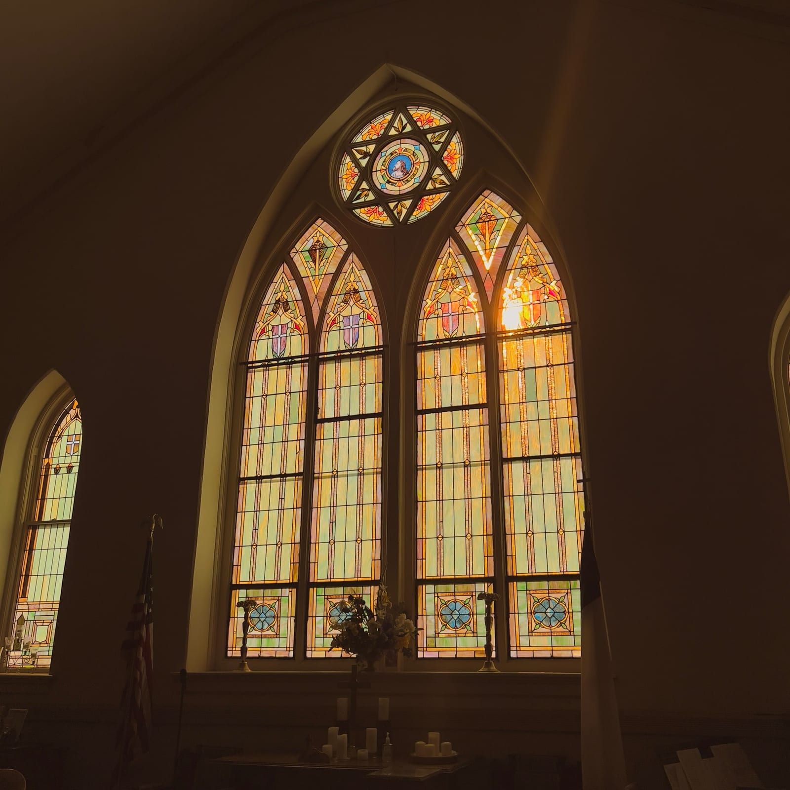 Tall stained-glass windows glowing above the chancel